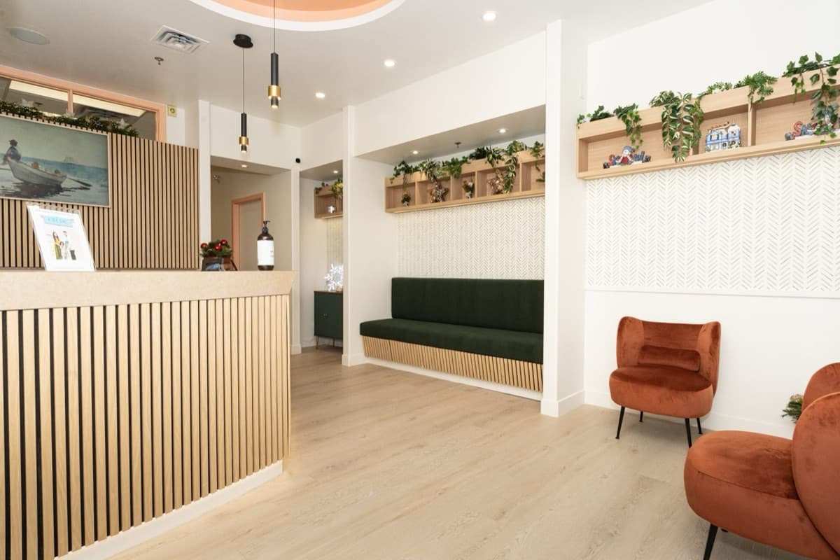 Modern orthodontic practice reception area with waiting lounge